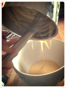 Scraping yolks into a bowl to cool.